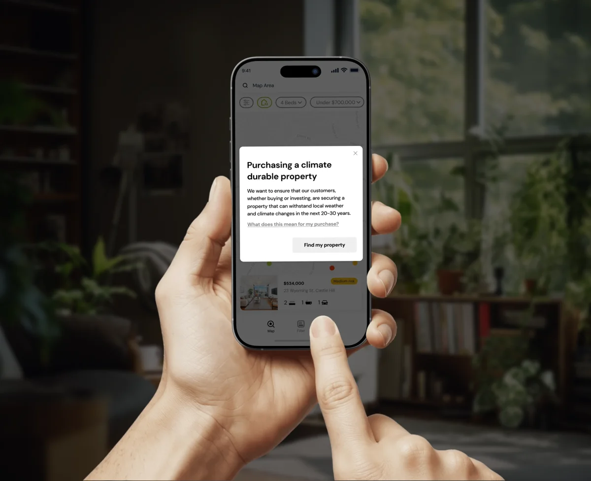 Climate risk app on a phone held in a home